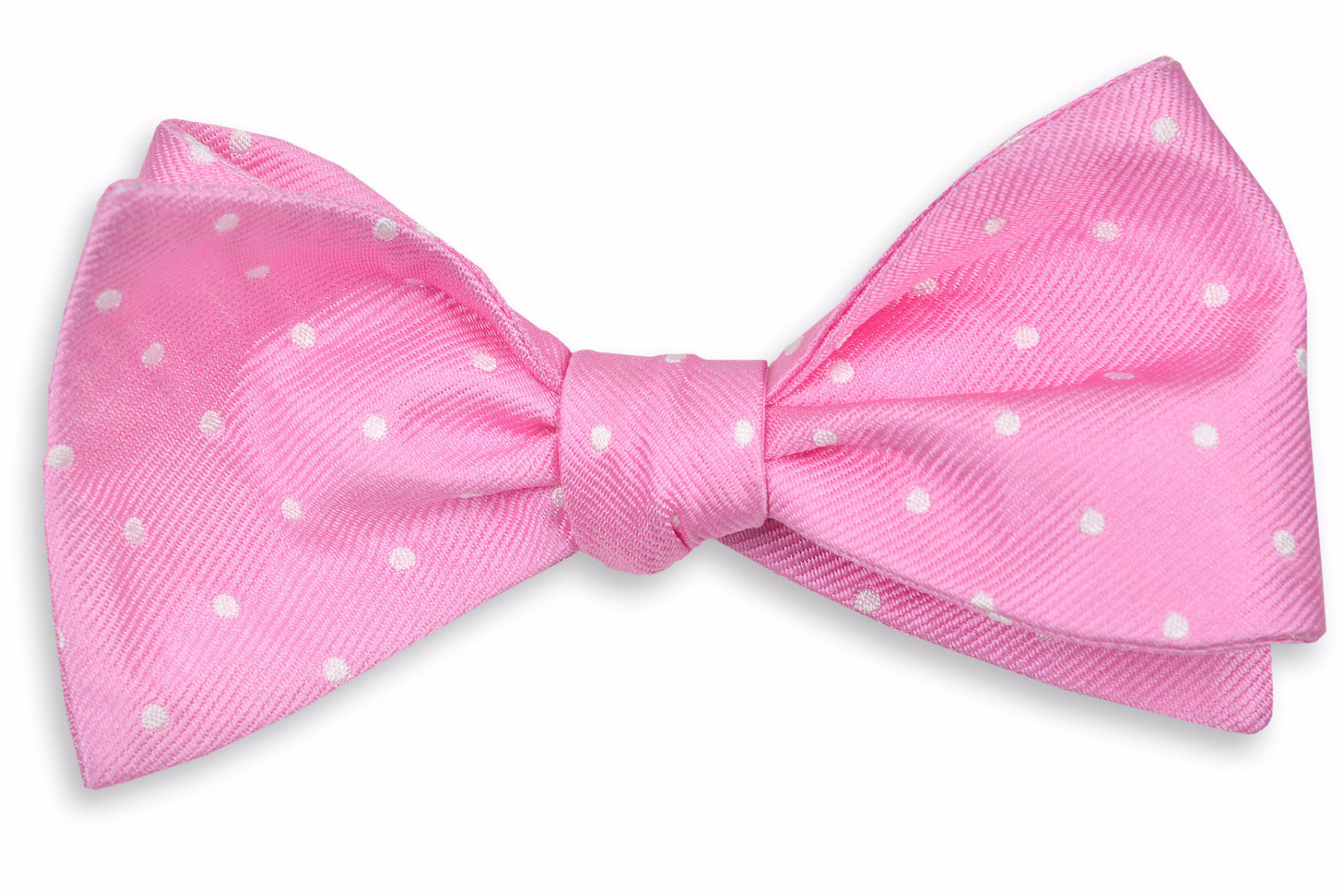 Men's pink bow tie. Made from 100% silk featuring white polka dots.