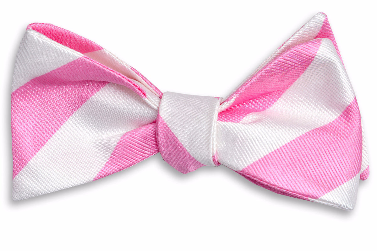 Men&#39;s pink bow tie. Made from 100% silk featuring white stripes.
