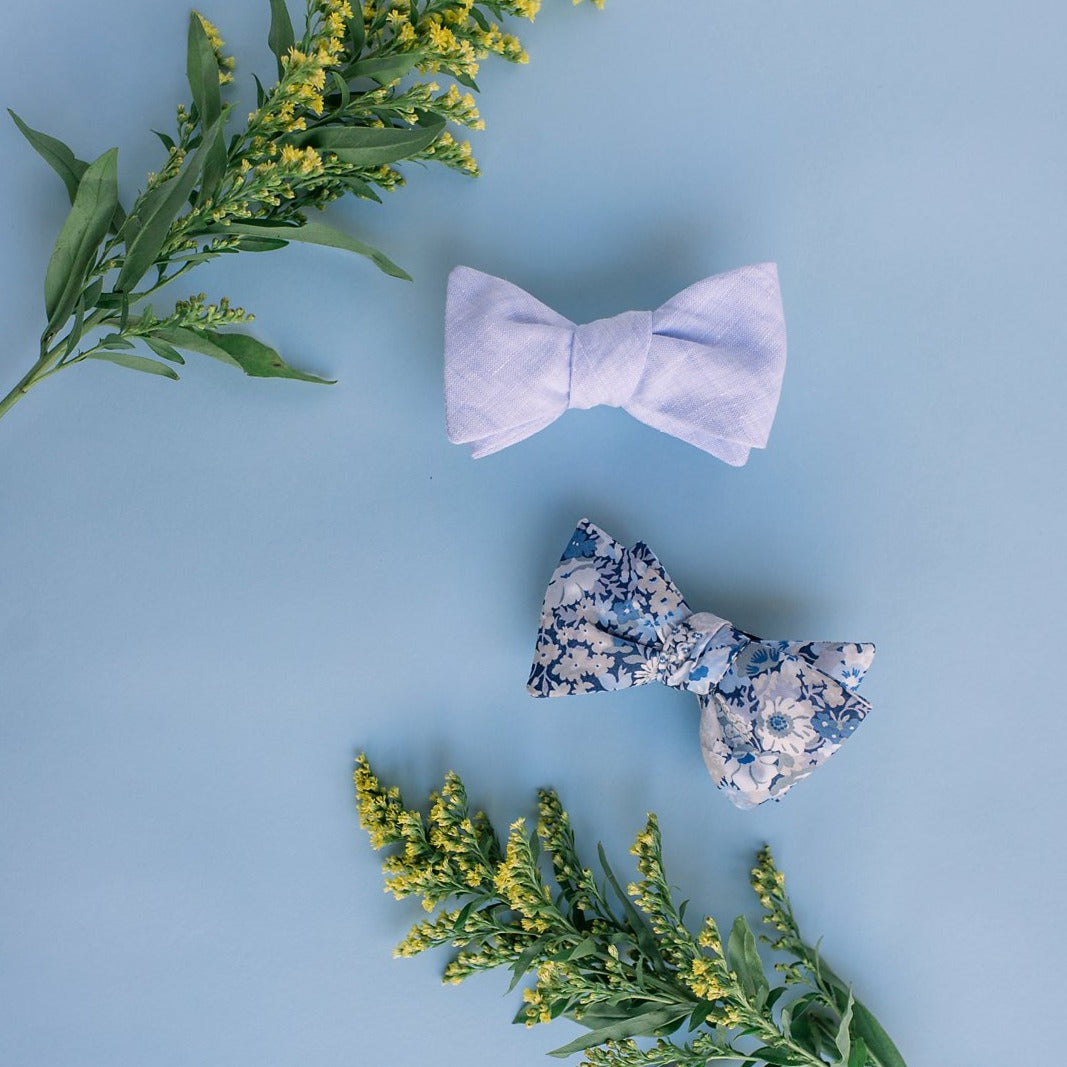 Mens cotton self tie bow tie featuring a blue floral pattern. 
