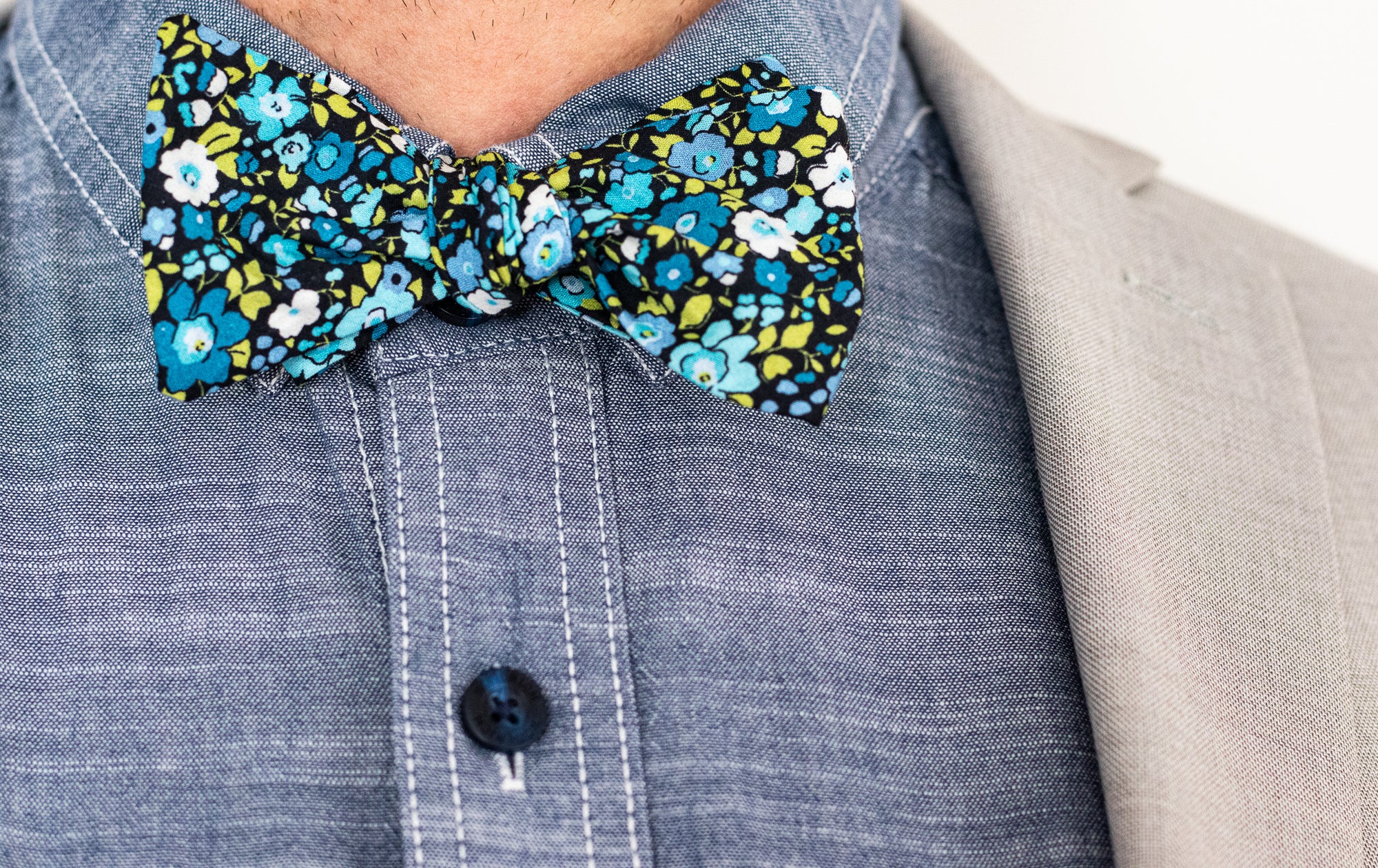 cotton mens bow tie featuring a blue floral pattern.