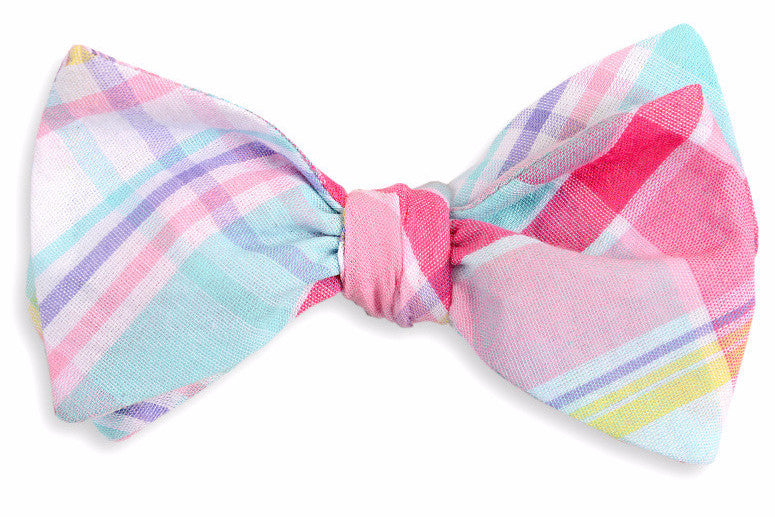 Men&#39;s pink bow tie. Made from 100% cotton featuring a multi-colored plaid pattern.