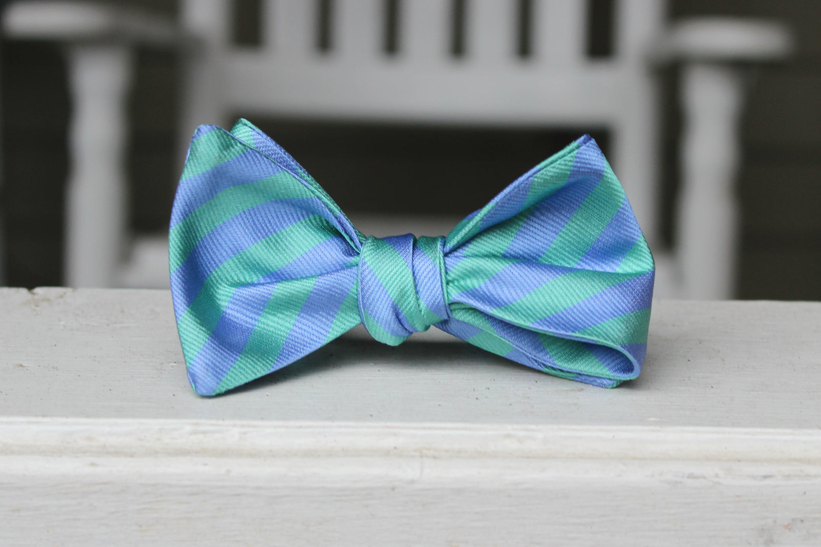 silk mens self tie bow tie with light blue and teal stripes.