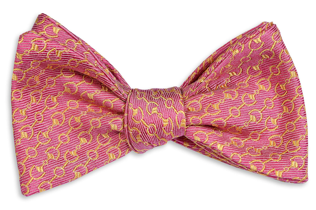 Men&#39;s pink bow tie. Made from silk featuring a pattern of horse bits.