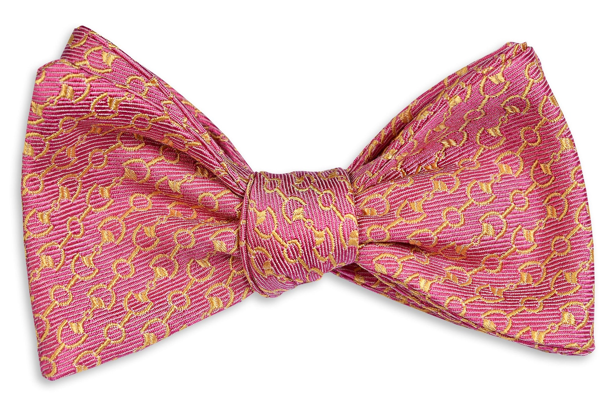 Men's pink bow tie. Made from silk featuring a pattern of horse bits.