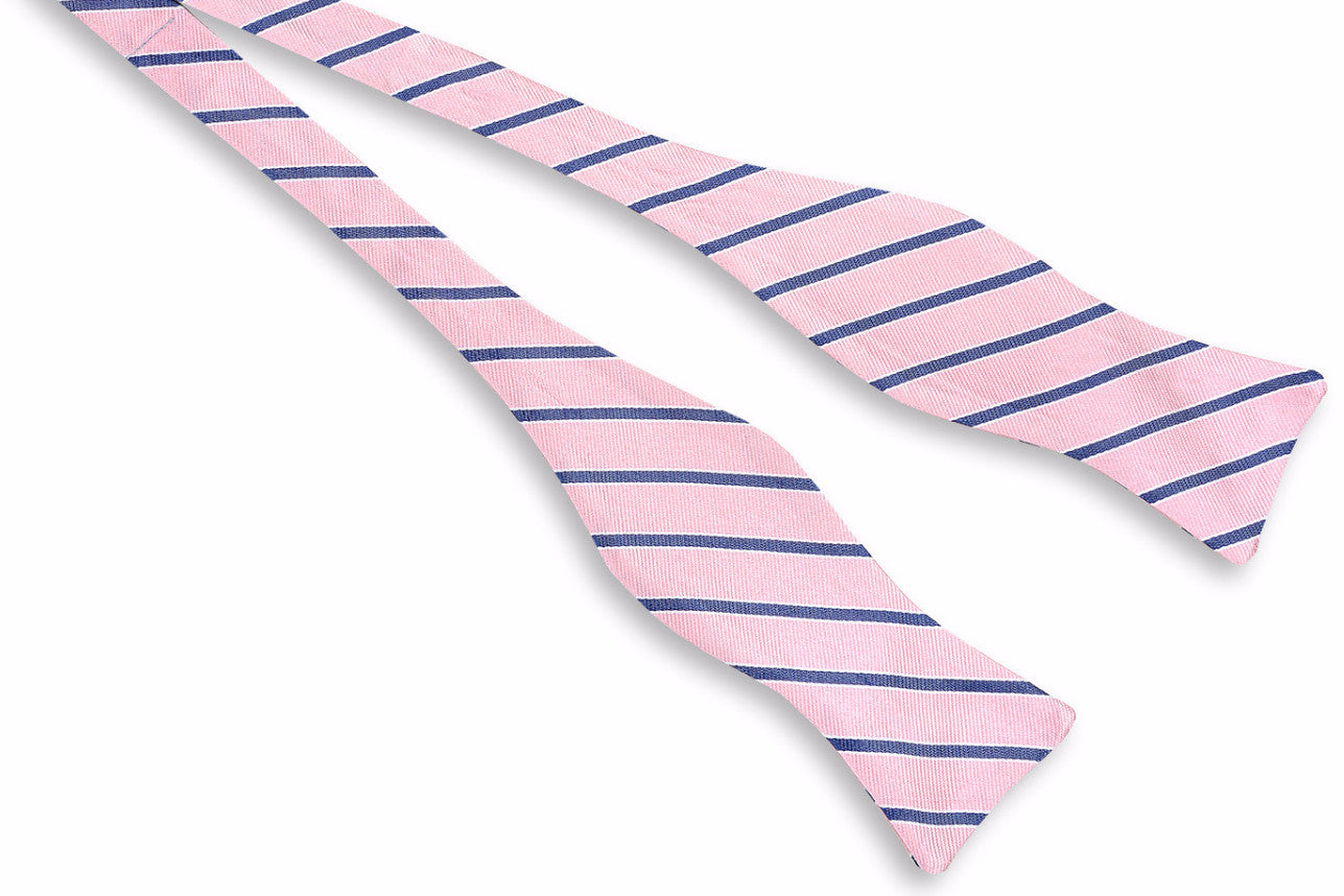 Pink men's bow tie. Made from 100% silk featuring blue stripes.