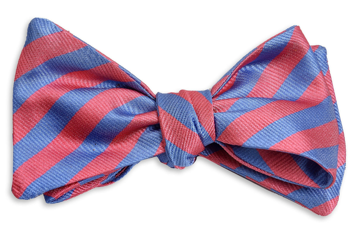 Pink and blue men&#39;s bow tie. Made from 100% silk with a striped pattern.
