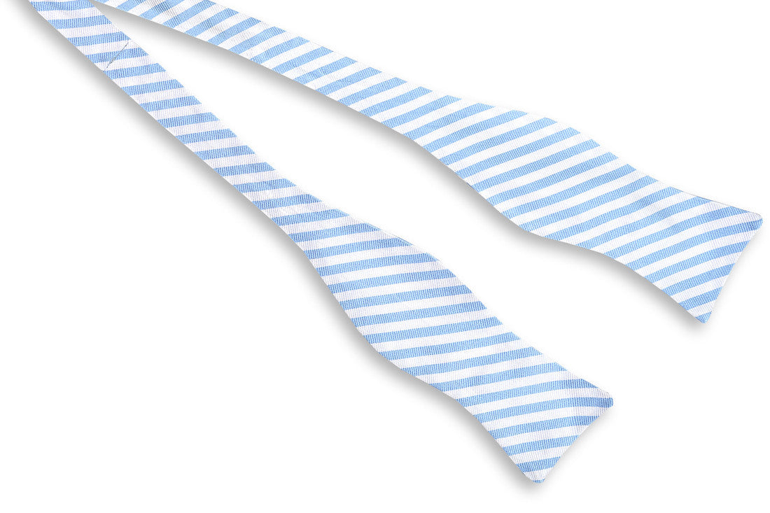 Carolina blue, silk, mens bow tie featuring a white stripe pattern.