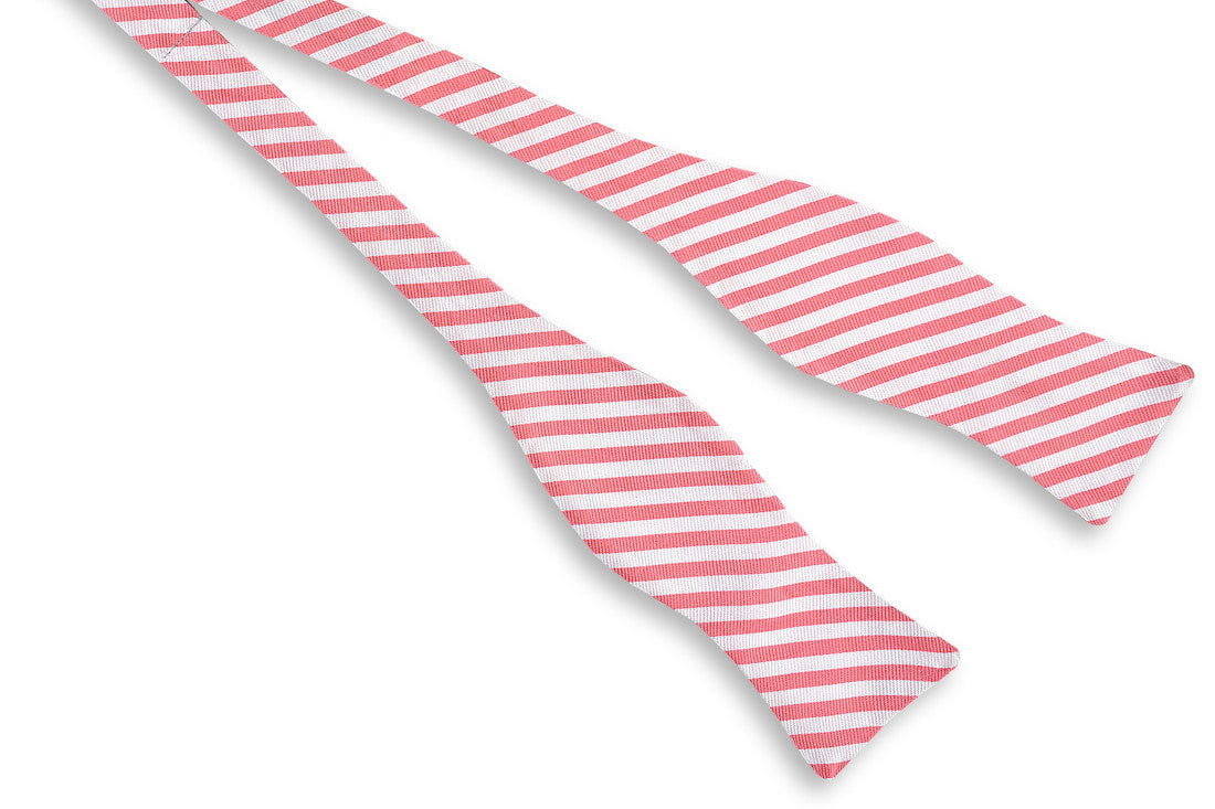Men's pink bow tie. 100% silk with a white striped design.