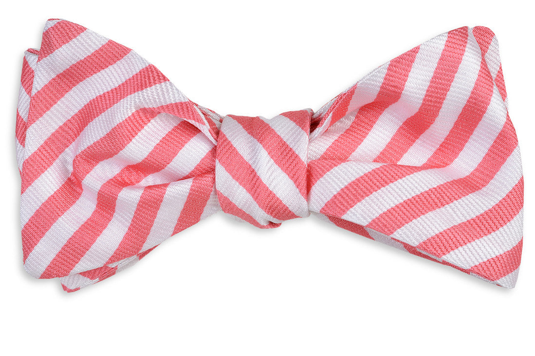 Men's pink bow tie. 100% silk with a white striped design.