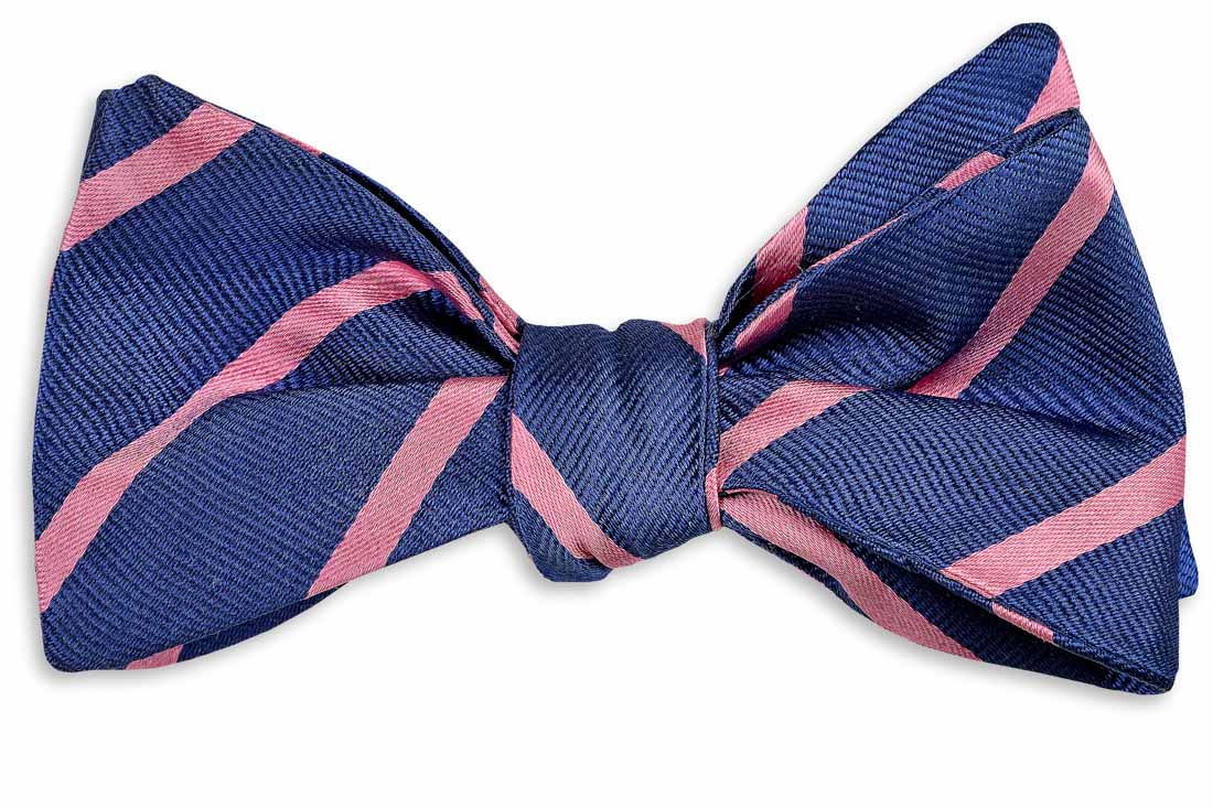 Men&#39;s navy and pink bow tie. 100% silk with a striped pattern.